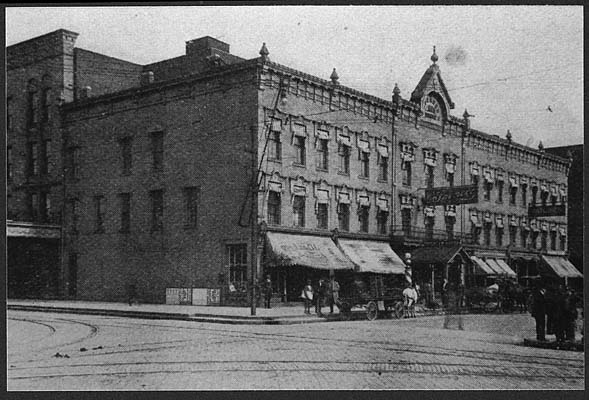 (1910) Exterior view of Spencer Hotel with awnings on the front of the building