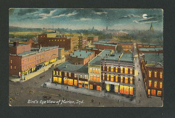 (ca. 1900) Night view, taken from courthouse, shows Adams St. on left and Washington St. on right, looking south. Spencer Hotel on left