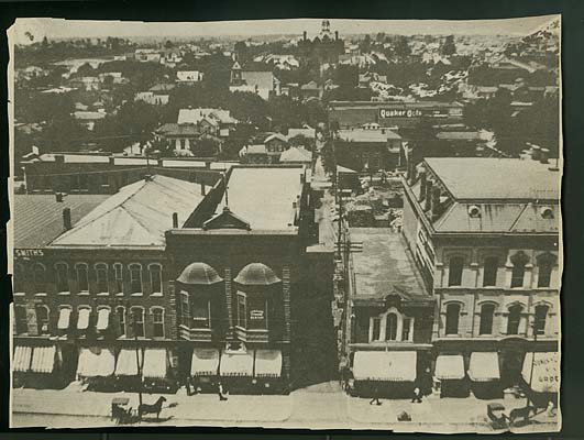 View of the west side of the square, taken from the top of the courthouse. At the top of the photo is the old Marion High School building.